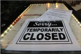  ??  ?? A closed sign is posted at a restaurant along the River Walk in San Antonio in this file photo. Banks reported a little more success late last week in getting small business owners’ applicatio­ns for coronaviru­s relief loans into government processing systems.
(AP/Eric Gay)