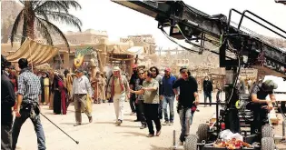  ?? MO H A MMAD F O G H A N I / T H E A S S O C I AT E D P R E S S ?? Iranian filmmaker Majid Majidi, centre, during the making of Muhammad, Messenger of God. Sunni Islam rejects any depictions of Muhammad, but Shiite Islam does not.
