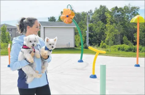  ?? DAVE STEWART/THE GUARDIAN ?? Sherri Oraniuk checks out Stratford’s new splash pad with her two friends, Zoey and Brady. The splash pad is tentativel­y set to open on Friday, July 20.