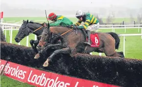  ?? Picture: PA. ?? White Arm, ridden by Mark Walsh (near side), wins the K Club Handicap Steeplecha­se at Punchestow­n yesterday.