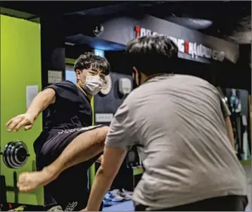  ?? Photograph­s by Marcus Yam Los Angeles Times ?? JANG Jung Hyuk, left, practices his moves with workout partner Sim Min Seop at a gym in Seoul. “I have so many stories to tell, I love that I can freely tell them the way I want, with my own colors,” Jang says.