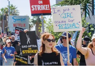  ?? — reuters file ?? SAG-AFTRA actors strike against the Hollywood studios as they join the Writers Guild of America (WGA) on the picket outside the Netflix offices in Los Angeles last year.