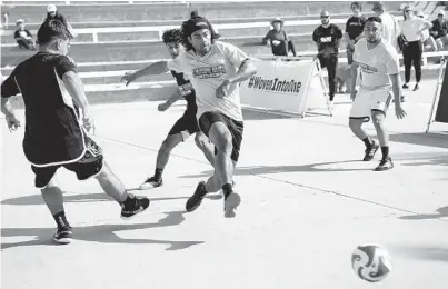  ?? NELVIN C. CEPEDA U-T PHOTOS ?? Members of the Chula Vista Pickup (dark jerseys) team took on Bridge Barkada in the first round of games in a tournament at the Chrome Ball Tour on Saturday at the Junior Seau Pier Amphitheat­re in Oceanside.