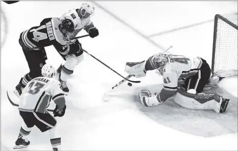  ??  ?? Chris Wagner (No.14) of the Boston Bruins takes a shot on goalie Mike Smith of the Calgary Flames during the first period of their 2018 NHL China Games hockey game in Beijing on Wednesday.