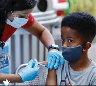  ?? AL SEIB — LOS ANGELES TIMES/POLARIS ?? Seven-year-old Ari Alleyne receives the children’s dose of the Pfizer COVID vaccine from RN Priya Meyer, Nursing Profession­al Developmen­t Mgr at Children’s Hospital Los Angeles Wednesday morning, Nov. 3, 2021.