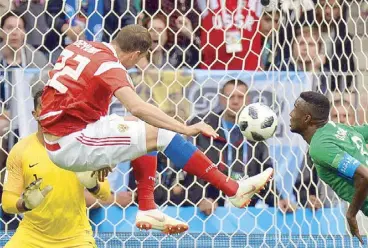  ?? EPA ?? Artyom Dzyuba (center) of Russia scores the 3-0 goal during their FIFA World Cup 2018 Group A preliminar­y round match with Saudi Arabia.