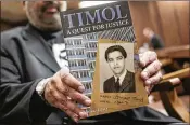  ?? AP ?? Imtiaz Cajee, nephew of Ahmed Timol, poses with his book, “Timol: A Quest for Justice,” in Pretoria, South Africa. A court has found that Timol did not kill himself by jumping from a 10th-floor window, as authoritie­s said in 1971.