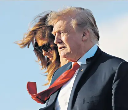  ??  ?? Donald and Melania Trump arrive at Palm Beach Internatio­nal Airport in Florida where they are spending the Easter weekend at his Mar-a-lago estate