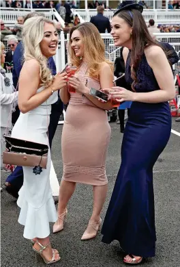  ??  ?? First day glamour: Racegoers get into the spirit yesterday