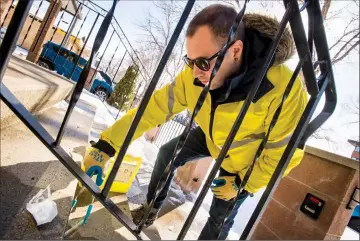  ?? Herald photos by Ian Martens ?? Graham Black, ARCHES needle pickup program co-ordinator, uses tongs to pick up drug parapherna­lia Tuesday afternoon from a set of steps at a property along 6 Avenue South. @IMartensHe­rald