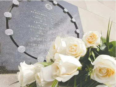  ?? PHIL CARPENTER/FILE ?? Fourteen white roses sit at the base of a memorial plaque at École Polytechni­que in Montreal on December 6, 2013, to remember 14 victims of the massacre. “As a society, we are being forced to face what women have always known: we experience violence, be it subtle and underminin­g, or obvious and dangerous, on a daily basis,” Leona Heillig writes.