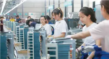  ?? — Reuters ?? Women work on a production line manufactur­ing air-conditione­rs, at a factory of an electrical engineerin­g company in Huaibei, Anhui province, China.