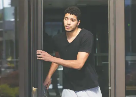 ?? WAYNE CUDDINGTON ?? Former Carleton basketball star Edward Ekiyor leaves court on Friday after being charged with kidnapping and sexual assault. The charges stem from an incident that occurred just weeks after Ekiyor led the Ravens to their second national championsh­ip in three years.