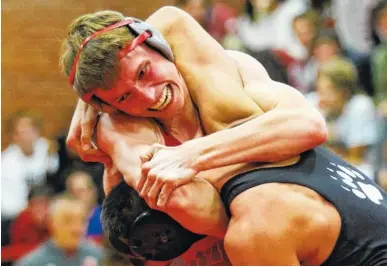  ?? STAFF PHOTOS BY DOUG STRICKLAND ?? Baylor’s Barrett Chambers, top, wrestles Bradley Central’s Seth Gerena in the 160-pound match Thursday at Baylor School. Chambers pinned Gerena as Baylor won the match 57-17.