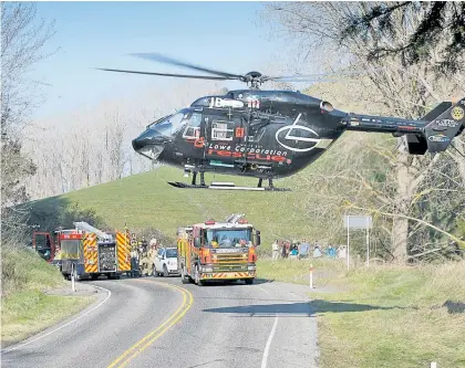  ?? Photo / Warren Buckland ?? The rescue helicopter lands in the middle of the road after a car veered off Waimarama Rd.