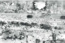  ?? — AFP photo ?? An image grab from a handout video released by the Israeli army shows what the army says are Gazans around aid trucks in Gaza City. Israeli forces shot dead 104 people when a crowd rushed towards aid trucks, the health ministry in Hamas-run Gaza said.