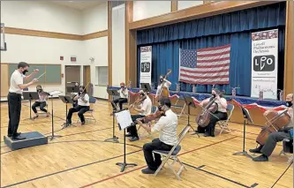  ?? COURTESY THE ORCHESTRA ?? Music Director and Conductor Thomas Kociela conducts a smaller group of string players from the orchestra.