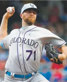  ?? Ron Jenkins, Getty Images ?? Rockies closer Wade Davis delivers during the ninth inning Sunday in one of his worst outings.