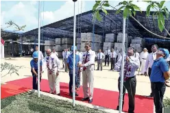  ??  ?? Representi­ng Tokyo Cement Company (Lanka) PLC Managing Director S.R. Gnanam, Chairman Dr. Harsha Cabral P.C. and Ready mix Concrete Chief Executive Officer M. Thayananth­an hoist flags at the new Tokyo Superlight plant in Elpitiya