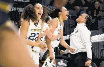  ?? Ronda Churchill Associated Press ?? UC IRVINE’S Clara Djoko (22) and Nevaeh Dean lead the cheers during the second half of the Big West tournament championsh­ip on Saturday night. The Anteaters women won their first tournament title since 1995.