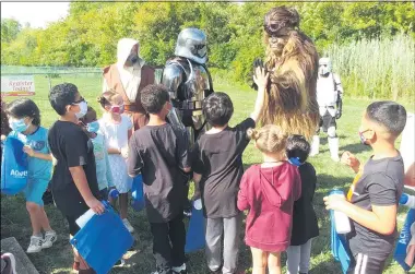  ?? ZACHARY SRNIS — THE MORNING JOURNAL ?? A Galaxy United, a Star Wars character group, visited Horizon Early Learning Centers in Lorain to pass out water bottles and drawstring bags from Achieve Credit Union.