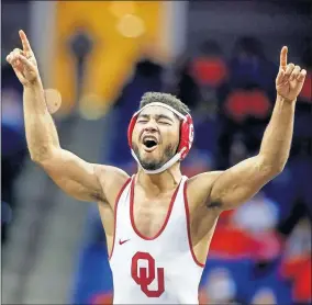  ?? [IAN MAULE/TULSA WORLD] ?? Oklahoma's Dominick Demas celebrates after pinning Oklahoma State's Kaid Brock during their Big 12 wrestling championsh­ip match at the BOK Center in Tulsa on Sunday.