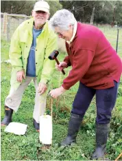  ??  ?? Left: Cannibal Creek Catchment Landcare Group president Gerard Cunningham and secretary Pam Cunningham plant trees at Tynong North.