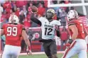  ?? GEORGE FREY/AP ?? Colorado quarterbac­k Brendon Lewis passes under pressure from Utah defensive tackle Tennessee Pututau, left, and defensive end Van Fillinger on Nov. 26 in Salt Lake City.