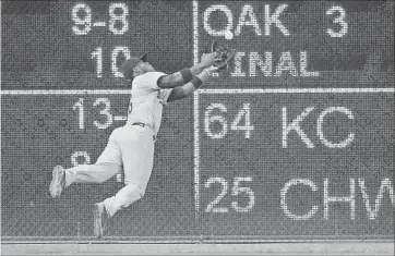  ?? Wilfredo Lee Associated Press ?? YASIEL PUIG of the Dodgers flags down a drive by Miami’s Martin Prado to the left-center-field gap for the last out in the seventh inning to preserve a perfect game for Rich Hill, who was removed after the inning.