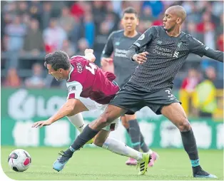  ??  ?? Liverpool’s Fabinho tackles Burnley’s Jack Cork in midfield