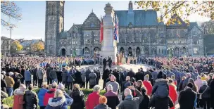  ??  ?? ●●Crowds gather around the Cenotaph in Rochdale.