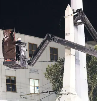  ?? AP ?? Workers dismantle the Liberty Place monument yesterday, which commemorat­es whites who tried to topple a biracial post-Civil War government, in New Orleans.