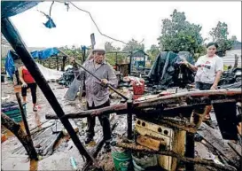  ?? MARCO UGARTE/AP ?? Family members begin the arduous task of clearing the damage to their home in Escuinapa, Mexico, on Wednesday in the aftermath of Hurricane Willa.