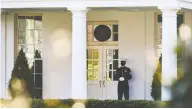  ?? ERIN SCOTT / REUTERS ?? A U.S. Marine guards the West Wing of the White House,
signalling that the president is in the Oval Office.