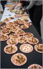  ?? ?? Slices of pizza are laid out during a media preview of the event April 19.