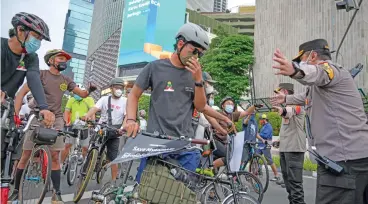  ?? (AFP) ?? Indonesian cyclists take part in a rally to show their their support for democracy in Myanmar near the Myanmar Embassy, in Jakarta on Saturday