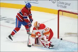  ?? Canadian Press photo ?? Montreal Canadiens' Tyler Toffoli scores a shorthande­d goal past Calgary Flames goaltender David Rittich during second period NHL hockey action in Montreal on Thursday.