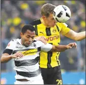  ?? (AFP) ?? Dortmund’s defender Matthias Ginter and Moenchengl­adbach’s Brazilian midfielder Raffael vie for the ball during the German first division Bundesliga football match of Borussia Dortmund vs Borussia Moenchengl­adbach in Dortmund, western Germany, on
Dec 3.