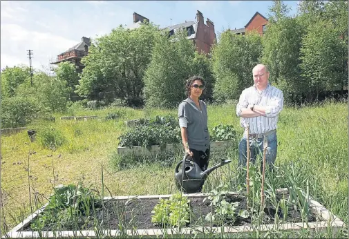  ??  ?? TAKING A STAND: Campaigner­s Karen Chung and Douglas Peacock are hoping to block council plans to sell North Kelvin Meadow for the developmen­t of 90 houses.