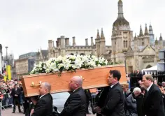  ??  ?? MOURNERS: The casket containing Professor Stephen Hawking is carried into the church in Cambridge. Photo: Joe Giddens/PA