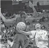  ?? Brett Coomer / Houston Chronicle ?? TSU guard Derrick Bruce gets under Prairie View A&M forward Keion Alexander, left, for a layup during the second half of Saturday’s game. Bruce had 22 points for the Tigers.