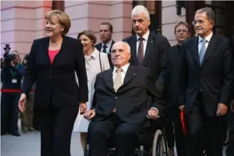  ??  ?? German Chancellor Angela Merkel and former Italian Prime Minister Romano Prodi (right) accompany former German Chancellor Helmut Kohl at a gala evening in his honour at the Deutsches Museum in 2012 (Getty)