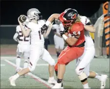  ?? Travis Simpson/Special to Siloam Sunday ?? Siloam Springs quarterbac­k Hunter Talley throws a pass as Russellvil­le’s Dalton Haulmark tries to get around a Siloam Springs offensive lineman. The Panthers defeated the Cyclones 50-47.