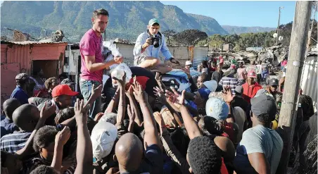  ?? PICTURE: DAVID RITCHIE ?? NOURISHMEN­T IN SHORT SUPPLY: Food parcels are distribute­d to people left homeless after a fire swept through the Imizamo Yethu informal settlement in this file photo. The writer says many people migrating from rural areas to the cities consume...