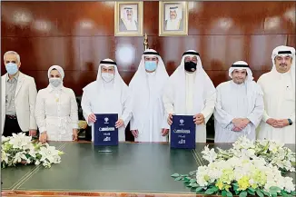  ?? KUNA photo ?? Officials of NCCAL and Kuwaiti Heritage Society in a group photo after the signing of MoU.