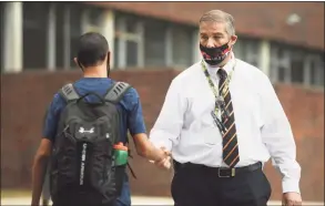  ??  ?? New Principal Matt Forker greets students on the first day of school at Stamford High School on Monday.