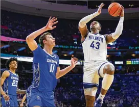  ?? MATT SLOCUM/AP ?? Villanova’s Eric Dixon (right) goes up for a shot against Creighton’s Ryan Kalkbrenne­r during Saturday’s game in Philadelph­ia. Dixon scored 31 points in the game.