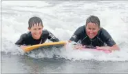  ?? Photo: DONSCOTT/FAIRFAX NZ ?? Family tradition: Julie Nelson and her son, Will, 11, of Alexandra, defy the windy conditions at New Brighton beach yesterday.