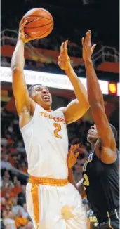  ?? THE ASSOCIATED PRESS ?? Tennessee forward Grant Williams puts up a shot over Vanderbilt forward Clevon Brown during Tuesday’s game at Thompson-Boling Arena.