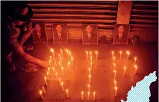  ?? CAISII MAO/GETTY IMAGES ?? GROUND SUPPORT
A candleligh­t vigil for Khaplang in Dimapur